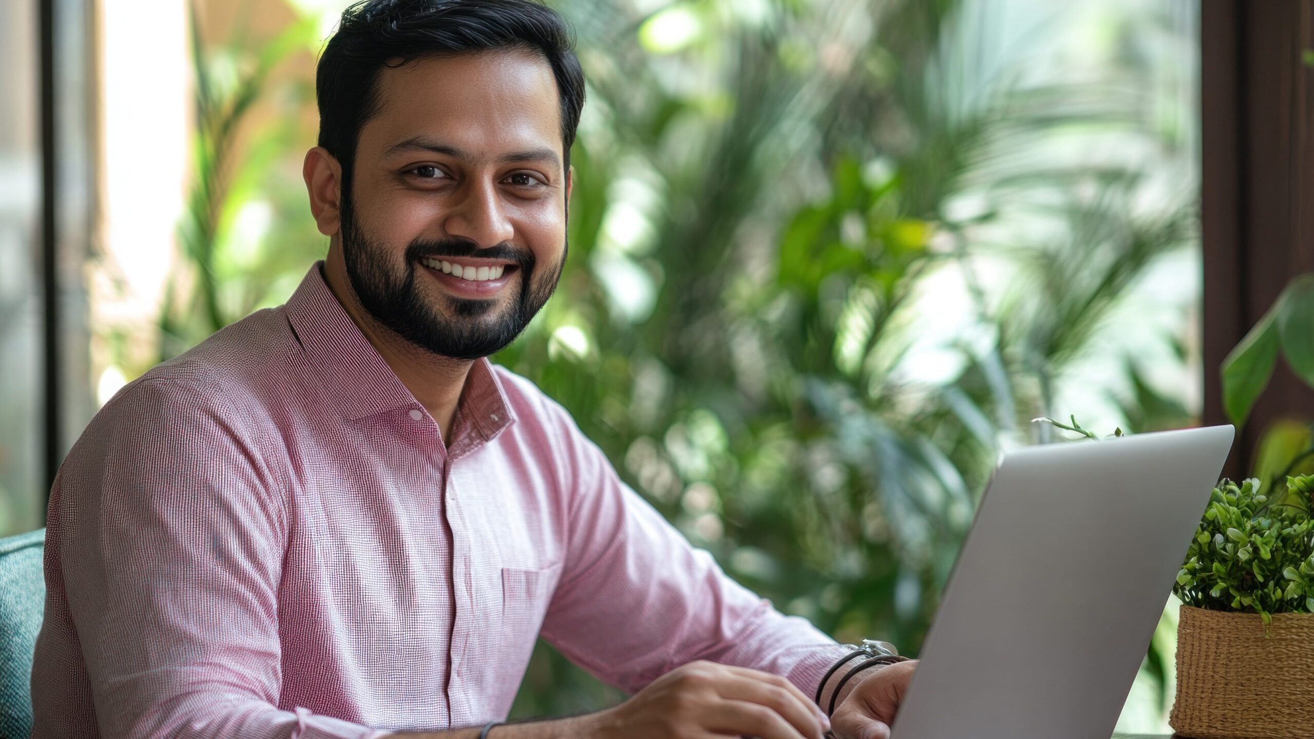 Indian businessman working from home using laptop at home office.